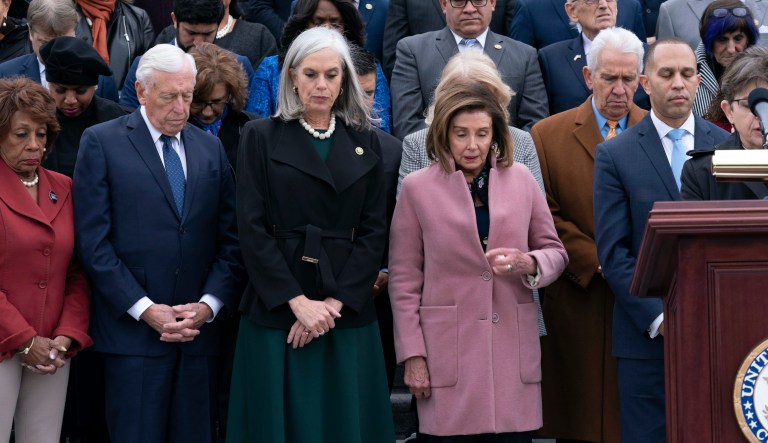 Incoming House Minority Leader Hakeem Jeffries, D-N.Y., accompanied by from left, Rep. Maxine Waters, D-Calif., Rep. Steny Hoyer, D-Md., incoming House Minority Whip Rep. Katherine Clark, D-Mass., Rep. Nancy Pelosi, D-Calif., along with members of Congress and family of fallen officers, pauses for a moment of silence during a ceremony marking the second year anniversary of the violent insurrection by supporters of then-President Donald Trump, in Washington, Friday, Jan. 6, 2023.