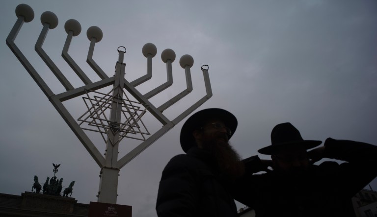 Rabbi Yehuda Teichtal, right, and Rabbi Segal Shmoel, left, inspect a giant Hanukkah Menorah, set up by the Jewish Chabad Educational Center ahead of the Jewish Hanukkah holiday, at the Pariser Platz in Berlin, Germany, Friday, Nov. 30, 2018.