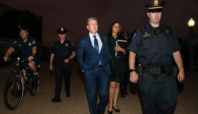 Kurt Volker, center, a former special envoy to Ukraine, is escorted as he leaves a closed-door interview with House investigators at the Capitol, Thursday, Oct. 3, 2019, in Washington.                                                                                                                                                                                                