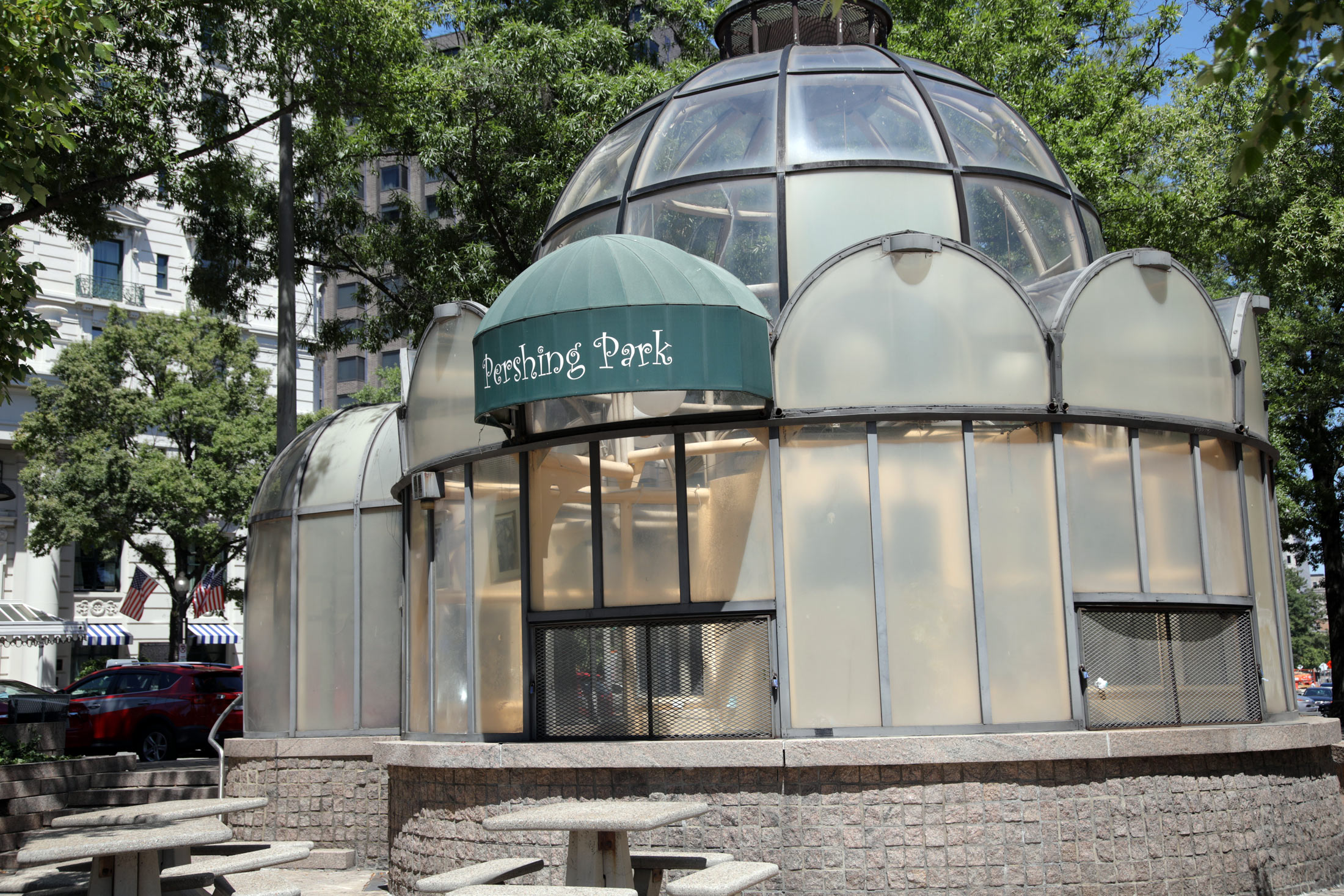 The Pershing Park refreshment stand, long abandoned, with its glazing of discolored plastic.