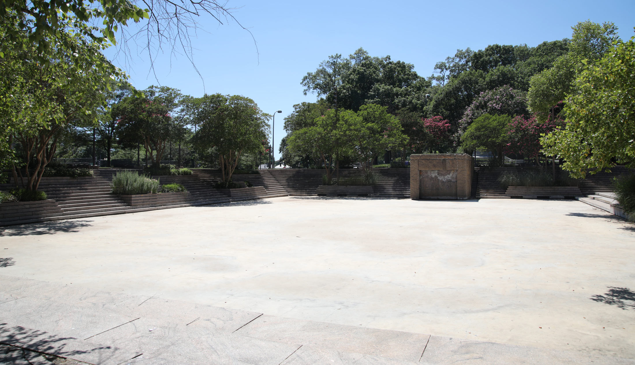 The empty pool and graffitied fountain box, which once doubled as a shed.