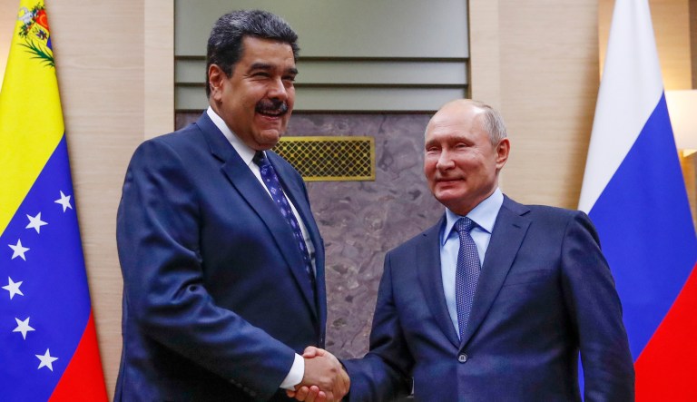 Russian President Vladimir Putin, right, shakes hands with his Venezuelan counterpart Nicolas Maduro during their meeting at the Novo-Ogaryovo residence outside in Moscow, Russia, Wednesday, Dec. 5, 2018.
