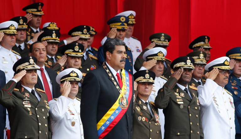 Venezuela's President Nicolas Maduro, center, stands with Armed Forces Commanders during a military parade at Fort Tiuna in Caracas, Venezuela, Thursday, May 24, 2018.