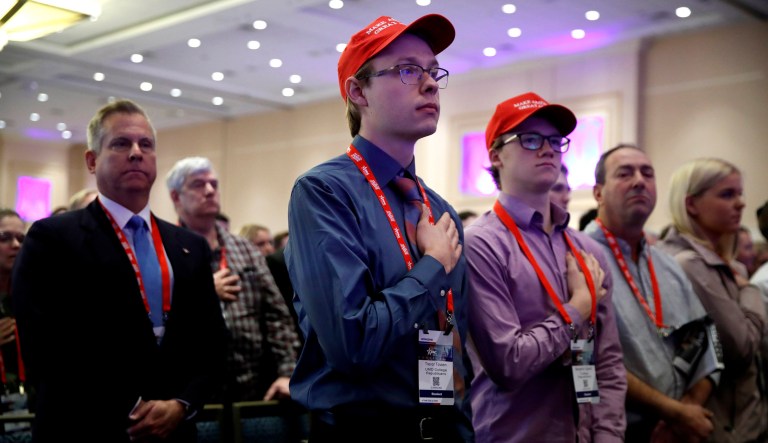 Trevor Tovsen, center, with the University of Minnesota Duluth College Republicans, says the Pledge of Allegiance, during the Conservative Political Action Conference, at National Harbor, Md., Friday, Feb. 23, 2018.