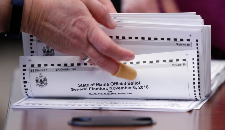 In this Nov. 12, 2018 file photo, ballots are prepared to be tabulated for Maine's 2nd Congressional District's House election in Augusta, Maine. Republican Rep. Bruce Poliquin and three voters sued Tuesday, Nov. 13, over Maine's new voting system, used for the first time in U.S. House and Senate elections. A lawyer for Poliquin's campaign asked the secretary of state to stop the tabulations to allow a judge to rule, but the secretary declined to stop the process.