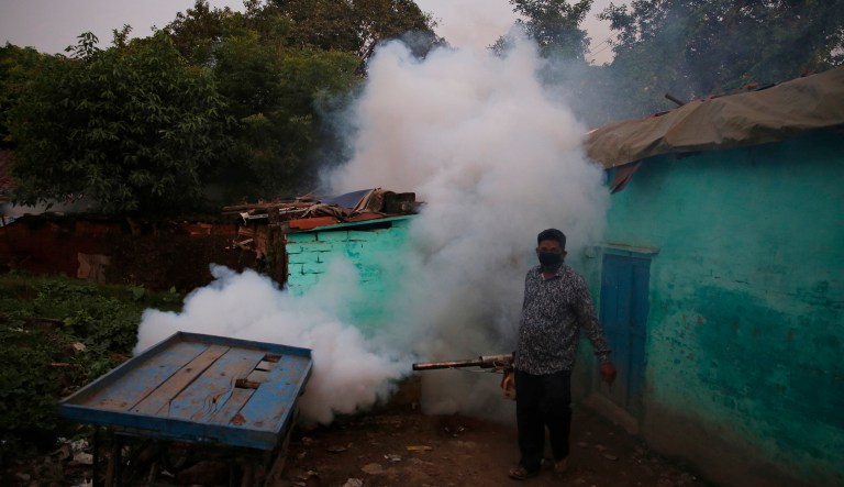 An Indian health worker fumigates an area to prevent the spread of mosquito-borne diseases in Allahabad, India, Thursday, Sept. 13, 2018. More than 200 million people live in impoverished Uttar Pradesh, India's most populous state. Thousands of people suffer from encephalitis, malaria, typhoid and other mosquito-borne diseases each year during the summer monsoon.