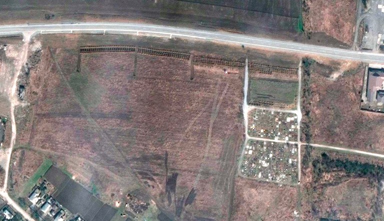 This satellite image provided by Maxar Technologies on Thursday shows an overview of the cemetery in Manhush, some 20 kilometers west of Mariupol, Ukraine, on April 3, 2022. The graves are aligned in four sections of linear rows (measuring approximately 85 meters per section) and contain more than 200 graves.