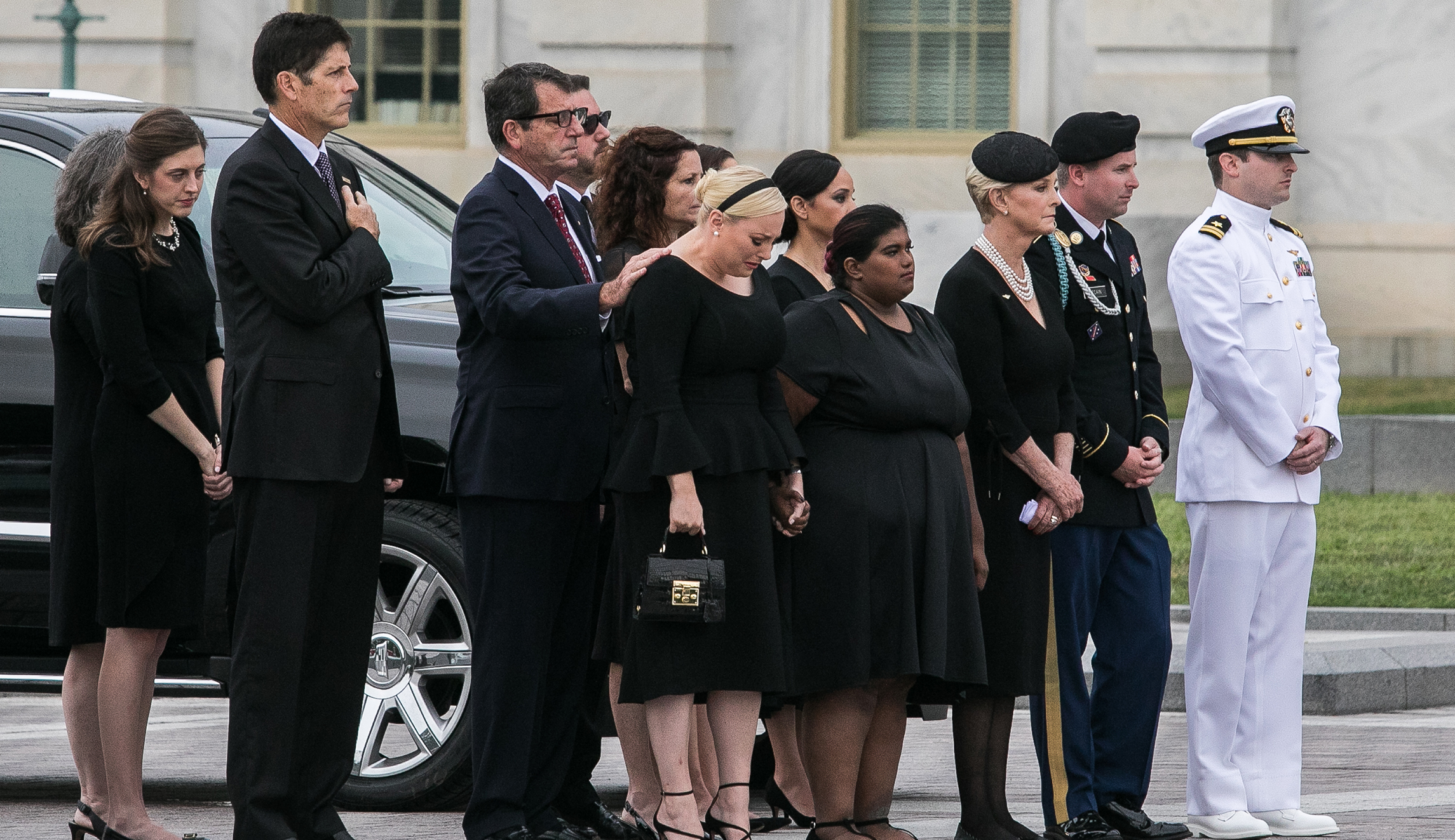 Sen. John McCain's daughter, Meghan (center), and other members of McCain's family appear as the casket leaves the Capitol in D.C. on Saturday.