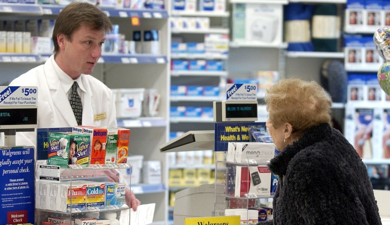 Pharmacist Greg Pankow speaks with a customer about her medication at a Walgreens Drug Store in Glenview, Illinois on Tuesday, November 25, 2003. 