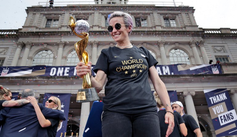 The U.S. women's soccer team member Megan Rapinoe holds the Women's World Cup trophy at City Hall after a ticker tape parade, Wednesday, July 10, 2019, in New York.