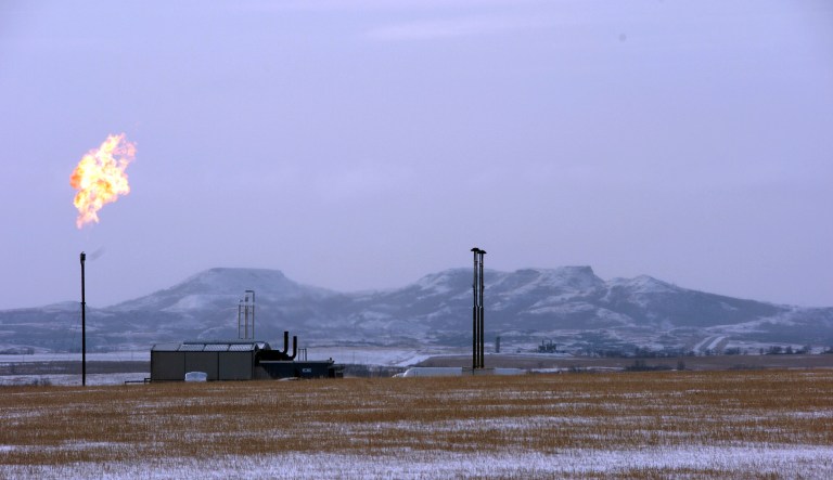 A gas flare is seen at a natural gas processing facility near Williston, N.D. Natural gas emits methane, a potent greenhouse gas.