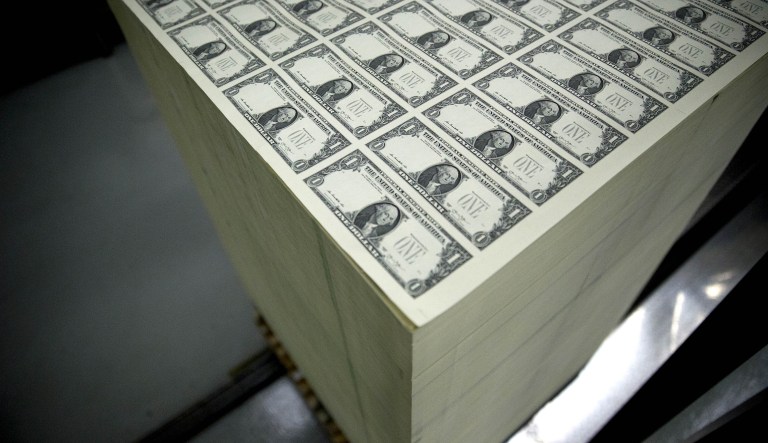 One dollar note sheets sit in a stack before receiving a serial number and the U.S. Treasury and U.S. Federal Reserve seals in Washington, D.C., U.S. The value of the dollar is rising as the Fed raises interest rates to combat the country's painful inflation.