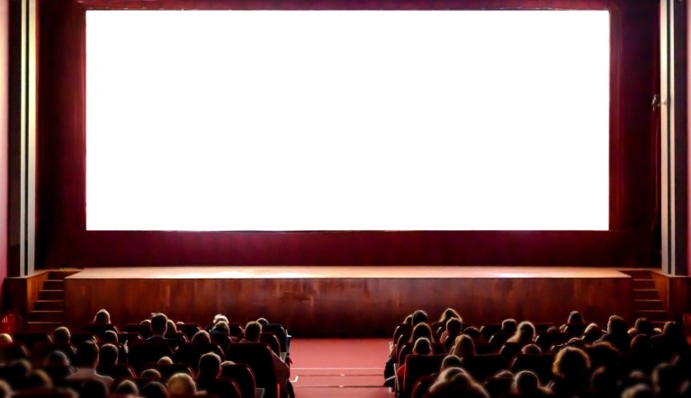 Cinema empty screen with audience. Blurred People silhouettes watching movie performance.