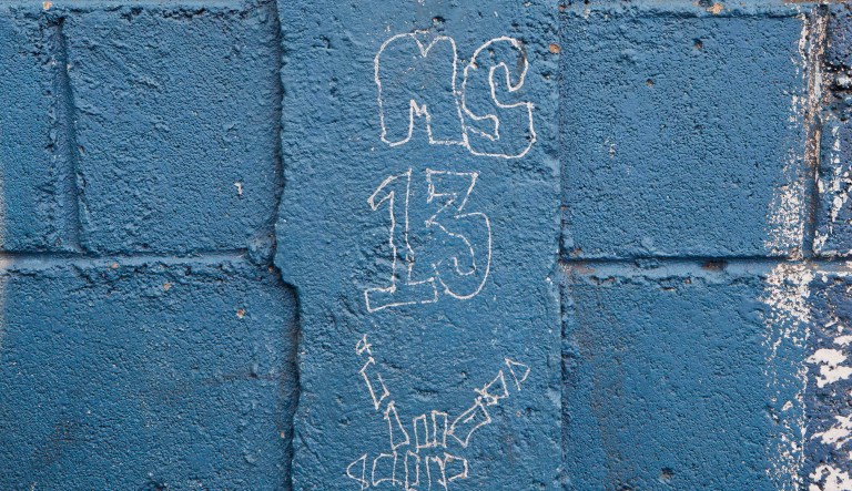 In this Nov. 28, 2014 photo, a MS-13 gang graffiti is painted next to door of the Jose Ramon Montoya school in a Travesia neighborhood in Tegucigalpa, Honduras. Until recently, dozens of gangsters controlled the second floor of this primary and secondary school, using it as a base to sell drugs and organize girls into prostitution. For the time being, authorities are back in control of Montoya, including the newly repainted second floor.  âWe painted the walls inside the school three weeks ago. Theyâll come put their tags on them again, and we will paint them again,â said teacher Marcio Pastrana. It is a routine he knows well after 35 years at the school.