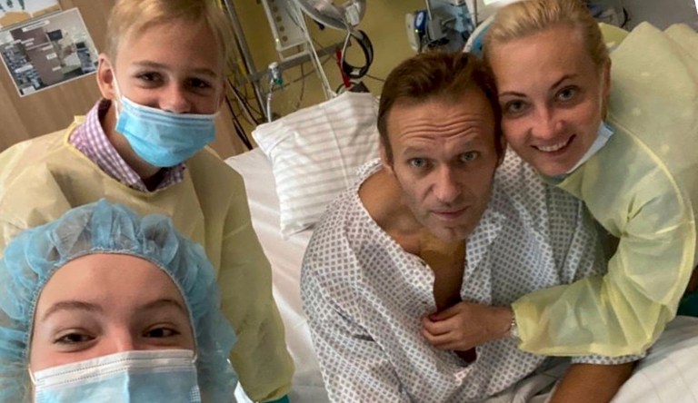 This handout photo published by Russian opposition leader Alexei Navalny on his Instagram account, shows himself, center, and his wife Yulia, right, daughter Daria, and son Zakhar, top left, posing for a photo in a hospital in Berlin, Germany. 