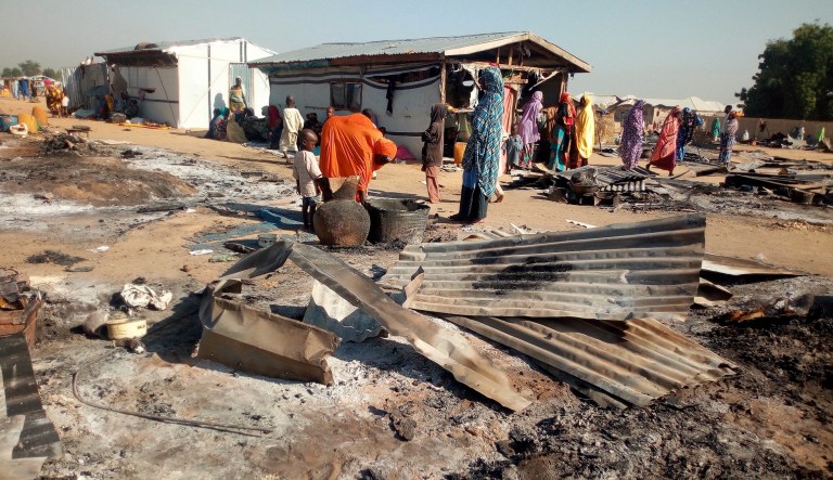 People gather at the site of an attack in Maiduguri, Nigeria, Thursday, Nov. 1, 2018.