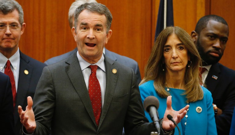 Virginia Gov. Ralph Northam, front, gestures during a news conference as House speaker Eileen Filler-Corn, right, and Secretary of Public safety Brian Moran, left, look on at the Capitol Thursday March 12 , 2020, in Richmond, Va. Northam declared a state of emergency due to the coronavirus outbreak.