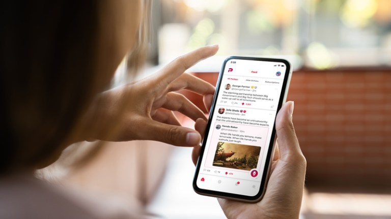 In this promotional image from Parler, a user scrolls through the social media app on a smartphone.