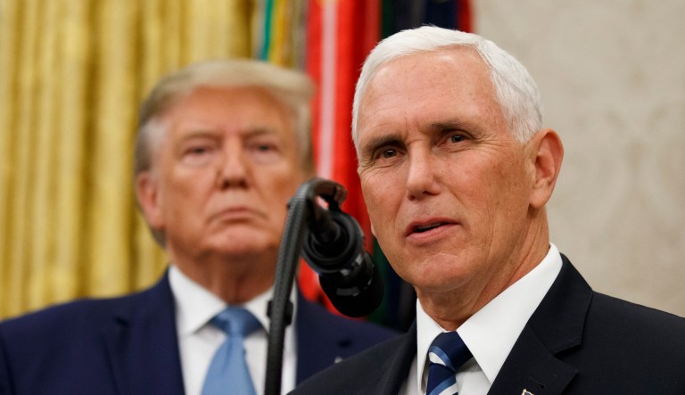 Vice President Mike Pence, right, speaks with President Donald Trump behind him, during a ceremony to present the Presidential Medal of Freedom to former Attorney General Edwin Meese, in the Oval Office of the White House, Tuesday, Oct. 8, 2019, in Washington.