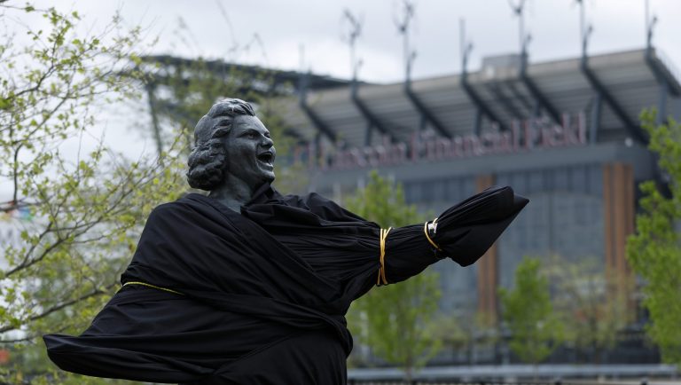 A partially covered statue of singer Kate Smith is seen near the Wells Fargo Center, Friday, April 19, 2019, in Philadelphia. The Philadelphia Flyers covered the statue of singer Kate Smith outside their arena, following the New York Yankees in cutting ties and looking into allegations of racism against the 1930s star with a popular recording of "God Bless America." Flyers officials said Friday they also plan to remove Smithâs recording of âGod Bless Americaâ from their library. They say several songs performed by Smith âcontain offensive lyrics that do not reflect our values as an organization.â 