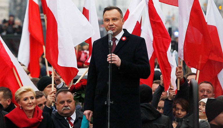 Poland's President Andrzej Duda speaks at the start of a massive march marking 100 years since Poland regained independence in Warsaw, Poland, Sunday, Nov. 11, 2018.