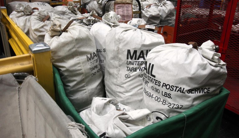 In this photo taken Feb. 24, 2012, sacks of mail for processing is seen at the Sacramento Processing Center in West Sacramento, Calif.  Elections officials in several states are concerned that the closing of mail-processing centers and post offices could disrupt vote-by-mail balloting this year.