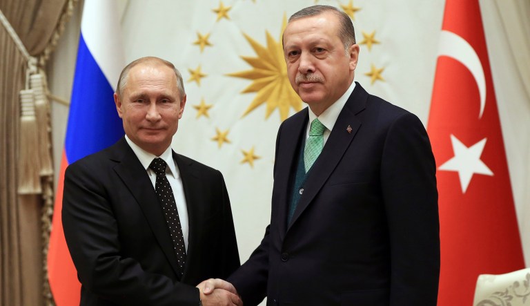 Turkey's President Recep Tayyip Erdogan, right, shakes hands with Russia's President Vladimir Putin, left, prior to their meeting at the Presidential Palace in Ankara, Monday, Dec. 11, 2017. Declaring a victory against "terrorists" in Syria, Putin earlier on Monday visited a Russian military air base in the country and announced a partial pullout of Russian forces from the Mideast nation.