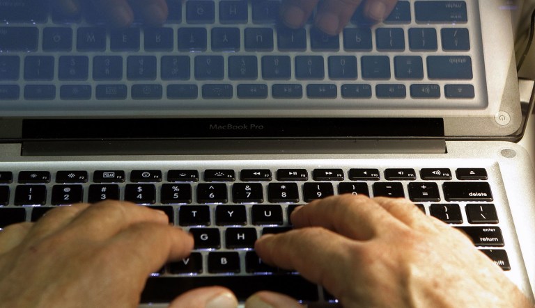 In this Feb. 27, 2013, file photo illustration, hands type on a computer keyboard in Los Angeles.