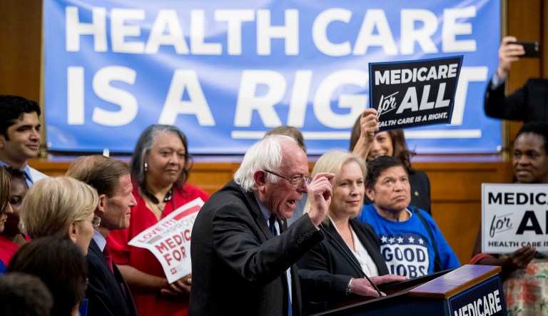 Sen. Bernie Sanders, I-Vt., center, accompanied by Sen. Kirsten Gillibrand, D-N.Y., center right, speaks at a news conference on Capitol Hill in Washington, Wednesday, Sept. 13, 2017, to unveil their Medicare for All legislation to reform health care.