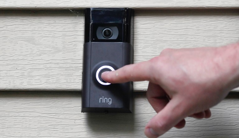  In this Tuesday, July 16, 2019, Ernie Field pushes the doorbell on his Ring doorbell camera at his home in Wolcott, Conn. (AP Photo/Jessica Hill)      