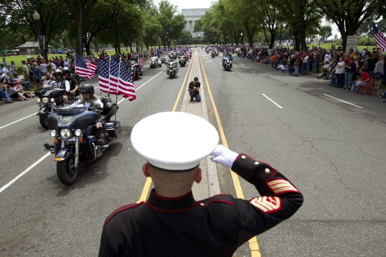 A Marine salutes as motorcycles drive past during the annual Rolling Thunder parade ahead of Memorial Day in Washington, Sunday, May 27, 2012.