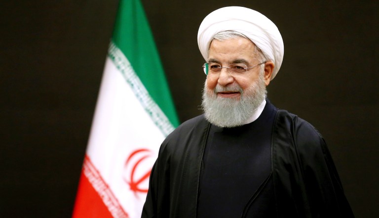 Iran's President Hassan Rouhani waits for Turkey's parliament speaker and former Prime Minister, Binali Yildirim, for their meeting, after a six-nation conference on fighting terrorism in Tehran, Iran, Saturday, Dec. 8, 2018. 