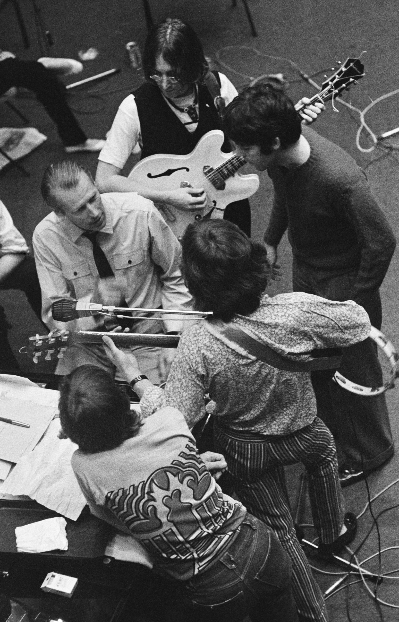 The Beatles with George Martin during a recording session at Trident Studios, 1968.
