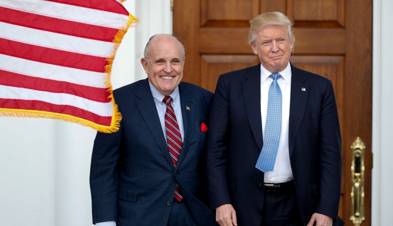 President-elect Donald Trump, right, and former New York Mayor Rudy Giuliani pose for photographs as Giuliani arrives at the Trump National Golf Club Bedminster clubhouse, Sunday, Nov. 20, 2016, in Bedminster, N.J.