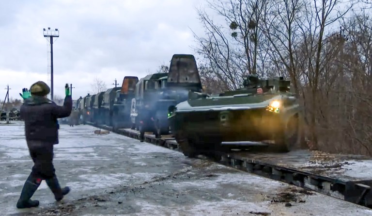 In this photo taken from video provided by the Russian Defense Ministry Press Service, A Russian armored vehicle drives off a railway platform after arrival in Belarus, Wednesday, Jan. 19, 2022. 