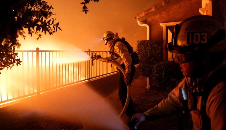 Los Angeles City firefighters battle the Saddleridge fire near homes in Sylmar, Calif., Thursday, Oct. 10, 2019.
