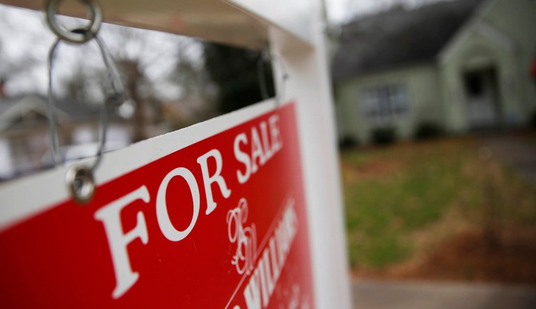 This Jan. 26, 2016 file photo shows a "For Sale" sign hanging in front of an existing home in Atlanta.
