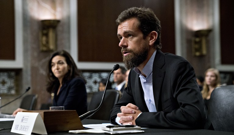 Jack Dorsey, co-founder and chief executive officer of Twitter Inc., speaks as Sheryl Sandberg, chief operating officer of Facebook Inc., left, listens during a Senate Intelligence Committee hearing in Washington, D.C., U.S., on Wednesday, Sept. 5, 2018. Lawmakers from both sides of the aisle have increased pressure on technology companies on Russian interference in the 2016 presidential campaign and other election meddling as well as issues including alleged anti-conservative bias and antitrust questions.