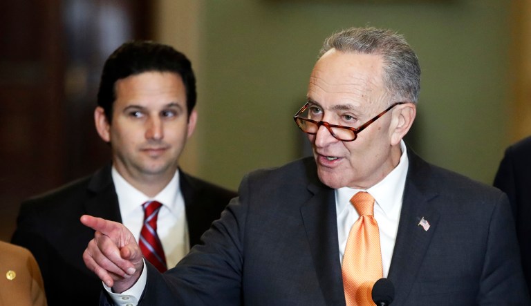 Senate Minority Leader Sen. Chuck Schumer speaks to the media with Sen. Brian Schatz of Hawaii on Capitol Hill in Washington. 
