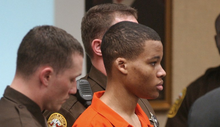 Sniper suspect Lee Boyd Malvo listens to court proceedings during the trial of fellow sniper suspect John Allen Muhammad in Virginia Beach, Va., Monday, Oct. 20, 2003. The lawyer for convicted teenage sniper Malvo says his client plans to drop all appeals of his conviction and life sentence for one of 10 sniper killings in October 2002 and admit his guilt in a second slaying. 