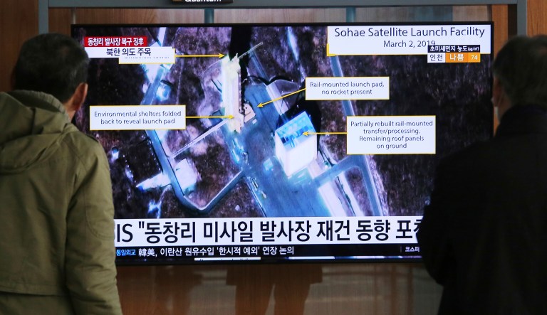 People watch a TV screen showing an image of the Sohae Satellite Launching Station in Tongchang-ri, North Korea, during a news program at the Seoul Railway Station in Seoul, South Korea, Wednesday, March 6, 2019. 