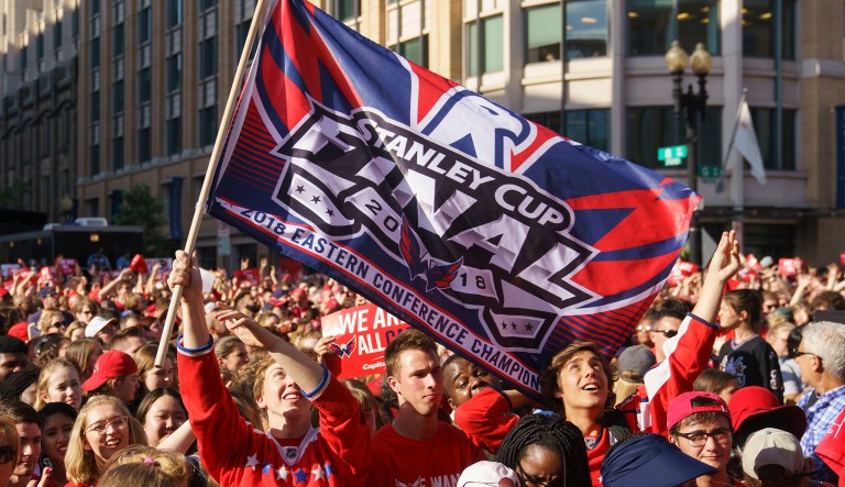 Fans cheer and wave a Stanley Cup Final flag before Game 4 of the NHL hockey Stanley Cup Final between the Washington Capitals and the Vegas Golden Knights, Monday, June 4, 2018, in Washington.