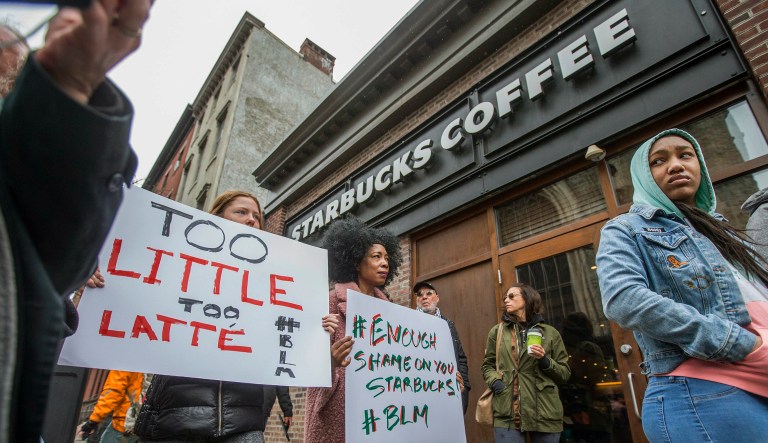 Protesters gather outside of a  Starbucks in Philadelphia, Sunday, April 15, 2018, where two black men were arrested Thursday after employees called police to say the men were trespassing. The arrest prompted accusations of racism on social media. Starbucks CEO Kevin Johnson posted a lengthy statement Saturday night, calling the situation "disheartening" and that it led to a "reprehensible" outcome.