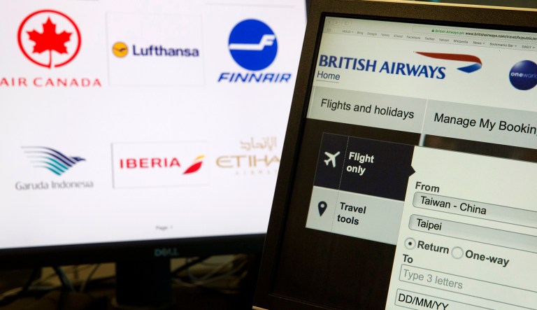In this May 21, 2018, photo, a computer screens display the booking website of British Airways showing "Taiwan-China" in Beijing, China.  Global airlines are obeying Beijing's demands to refer to Taiwan explicitly as a part of China, despite the White House's call this month to stand firm against such "Orwellian nonsense."