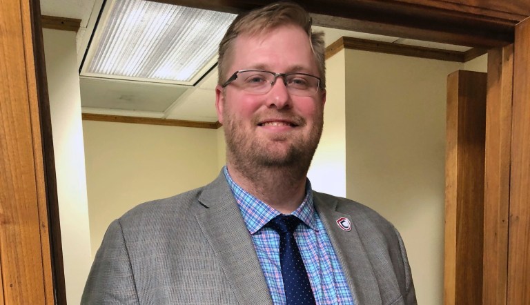 North Dakota Insurance Commissioner Jon Godfread poses for a portrait at the state Capitol in Bismarck, North Dakota, Thursday, March 28, 2019. Godfread, who claims he is 6-foot11 3/4 inches, is challenging New York City councilman Robert Cornegy Jr., a 6-foot-10 councilman from Brooklyn's claim of being the tallest male politician in the world. Comegy was  certified by Guinness World Records in January. 
