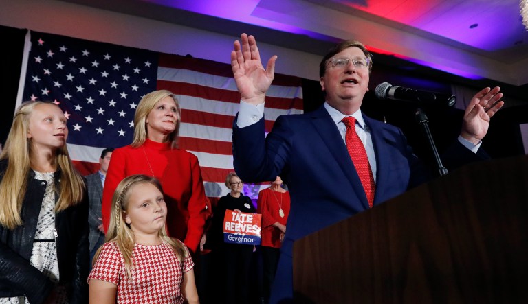 Republican Gov.-elect Tate Reeves addresses his supporters at a state GOP election night victory party, as wife, Elee Reeves, rear, and daughters Elizabeth, left, and Madeline, foreground, listen, Tuesday, Nov. 5, 2019, in Jackson, Miss. Reeves defeated Democratic Attorney General Jim Hood.