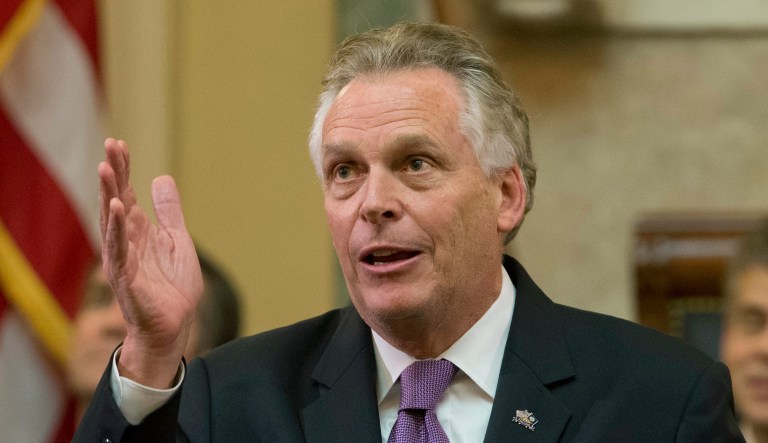 FILE - In this Jan. 10, 2018 file photo, Virginia Gov. Terry McAuliffe gestures as he addresses a joint session of the the 2018 session in the House chambers at the Capitol in Richmond, Va. McAuliffe told a national television audience heâd knock President Donald Trump to the floor if the president ever tried to intimidate him. During an interview Thursday, Jan. 11 on MSNBCâs âHardball,â Chris Matthews asked McAuliffe how he would respond if Trump tried to intimidate him during a debate by hovering over him, as he did in a 2016 debate with Hillary Clinton, a close friend of McAuliffeâs.