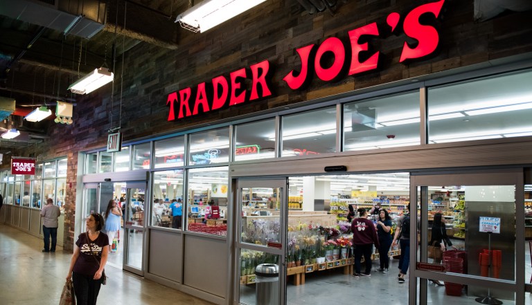 A shopper walks past a Trader Joe's grocery store inside DeKalb Market Hall at City Point in the Brooklyn borough of New York, U.S., on Wednesday, July 19, 2017. 