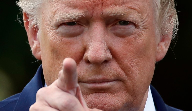 President Donald Trump points to a reporter for a questions as he speaks with reporters on the South Lawn of the White House before departing, Friday, July 19, 2019, in Washington.