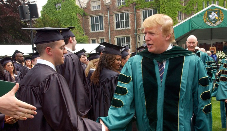 Donald Trump shakes hands with Wagner College graduates after receiving an honorary Doctor of Humane Letters degree during commencement exercises in the Staten Island borough of New York Friday, May 21, 2004.